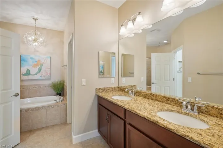 Bathroom with vanity, tile patterned floors, and shower with separate bathtub