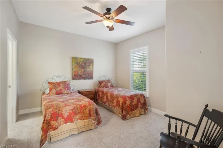 Carpeted bedroom with ceiling fan