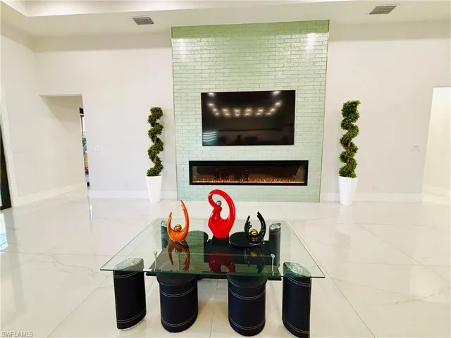 Detailed view of baseboards and a glass covered fireplace