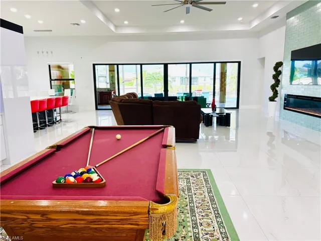 Playroom with billiards, a large fireplace, a ceiling fan, plenty of natural light, and recessed lighting