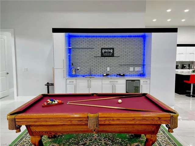 Recreation room with wine cooler, light tile patterned floors, billiards table, and recessed lighting