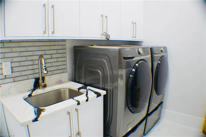 Laundry room with cabinet space and washing machine and clothes dryer