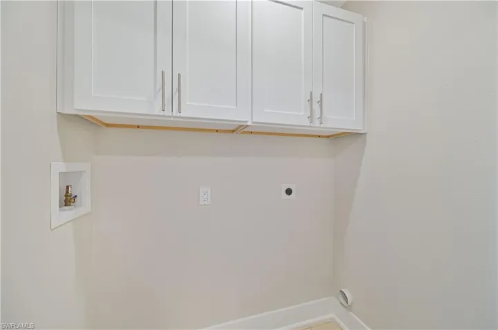 Washroom featuring washer hookup, cabinet space, and electric dryer hookup