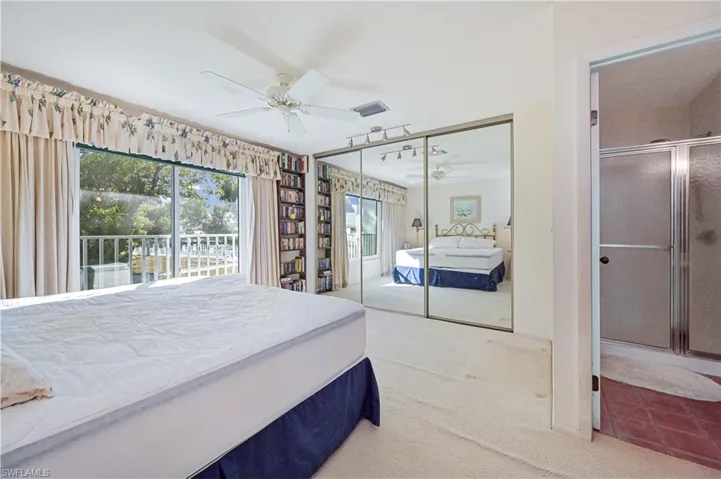 Bedroom featuring carpet flooring, a closet, access to exterior, and ceiling fan