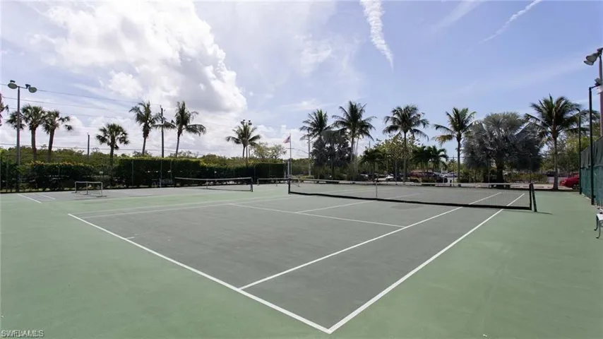 View of tennis court featuring community basketball court