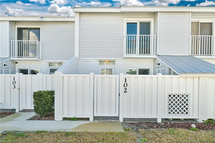 View of side of property with board and batten siding and a balcony