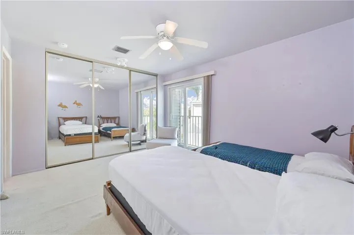 Carpeted bedroom featuring ceiling fan, access to outside, and a closet