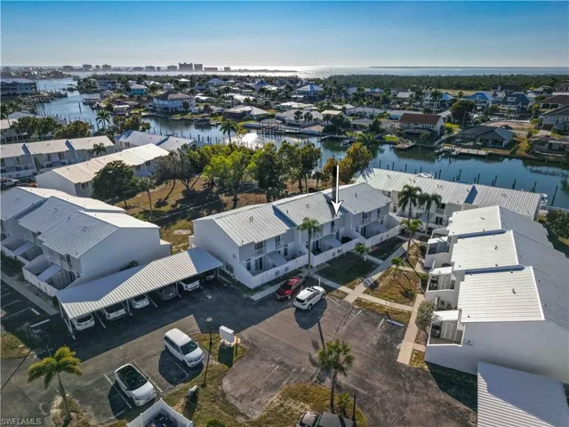 Aerial perspective of suburban area featuring a large body of water