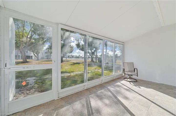 Unfurnished sunroom featuring vaulted ceiling