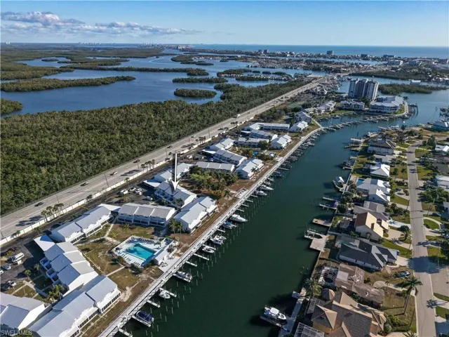 Aerial view of property's location featuring a large body of water