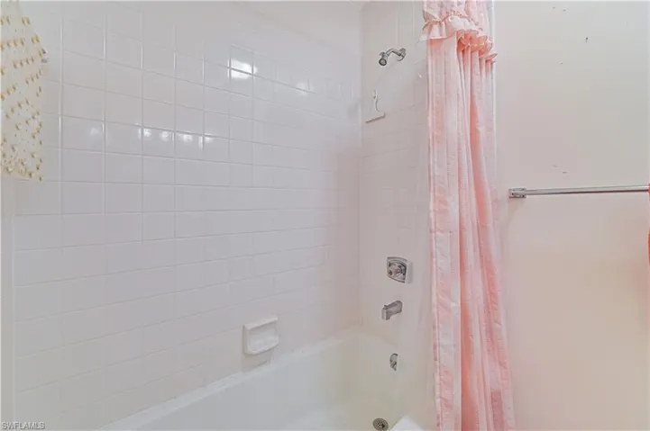 Bathroom with shower / bath combo with shower curtain