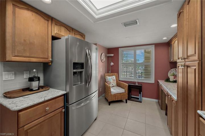 French door refrigerator, plantation shutters and impact glass window