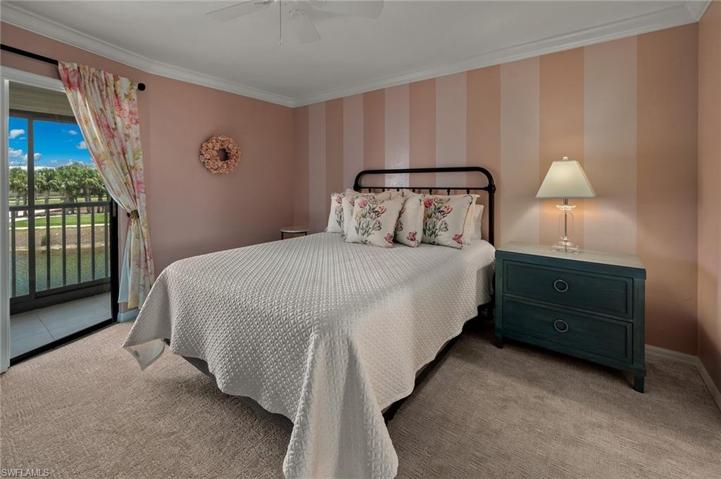 Spacious master bedroom with sliding plantation shutters and sliders to lanai