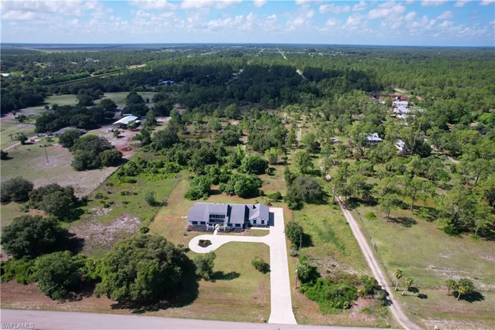 View of property location featuring a forest
