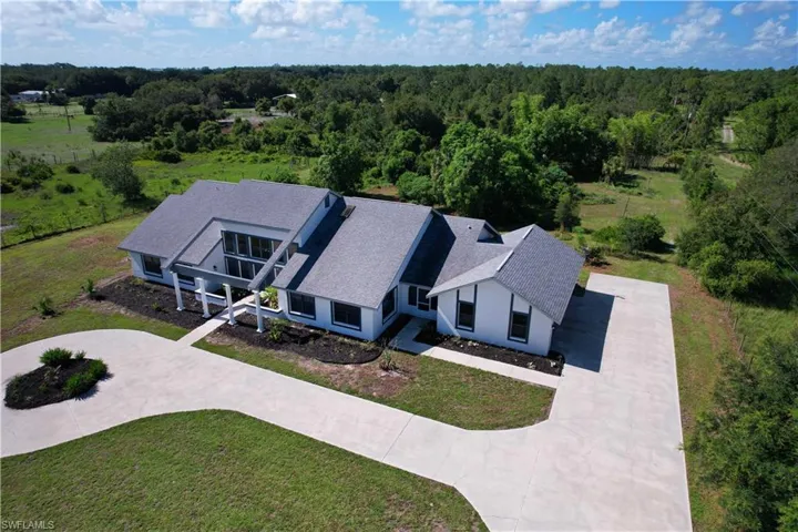 View of subject property featuring a heavily wooded area