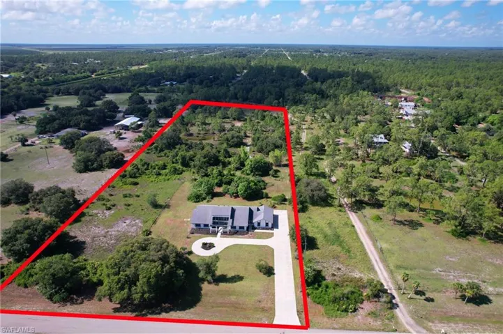 Aerial view of property's location featuring a heavily wooded area and property boundaries highlighted