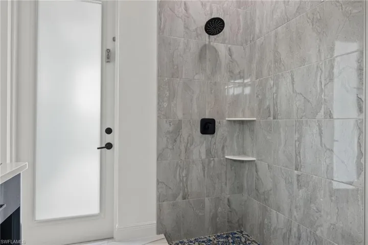 Bathroom featuring a tile shower