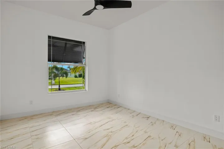 Empty room with baseboards and ceiling fan