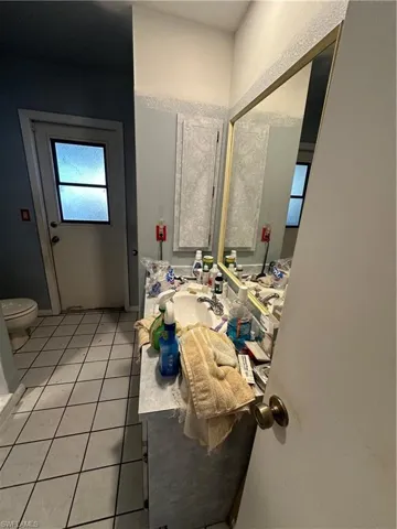 Bathroom with sink, tile flooring, and toilet