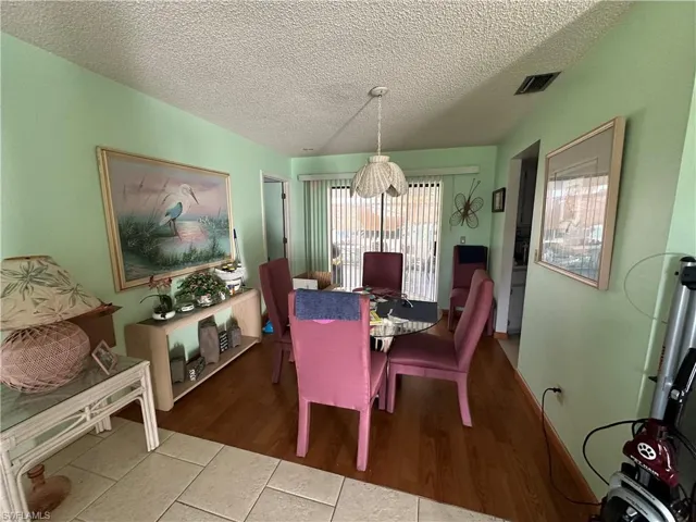 Dining room with tile floors and a textured ceiling