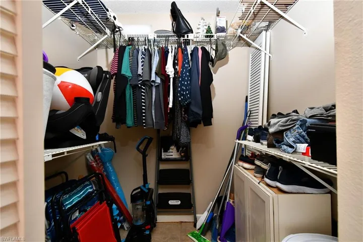 Walk in closet with tile patterned floors