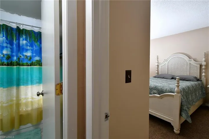 Bedroom featuring a textured ceiling and carpet flooring