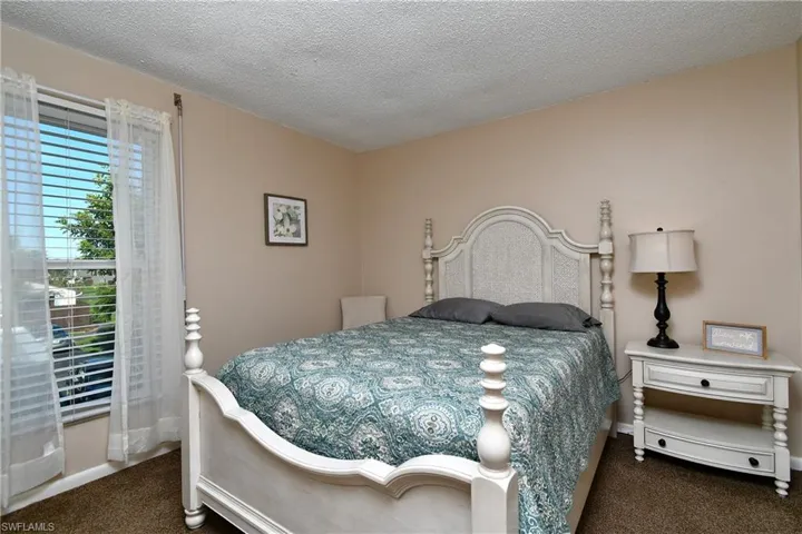 Carpeted bedroom with a textured ceiling