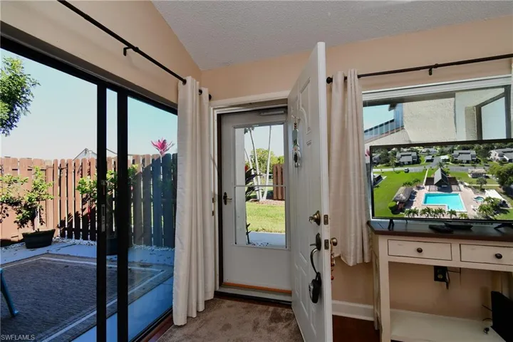 Entryway with a textured ceiling and vaulted ceiling