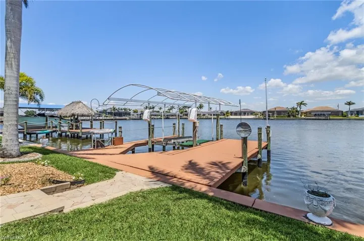 Dock area featuring boat lift and a water view