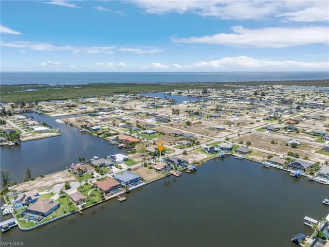 View of property location featuring a large body of water and nearby suburban area