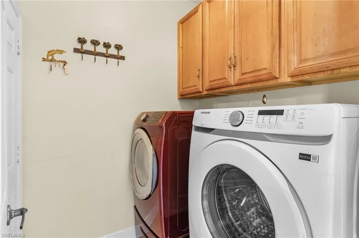 Laundry room featuring cabinet space, independent washer and dryer, and baseboards