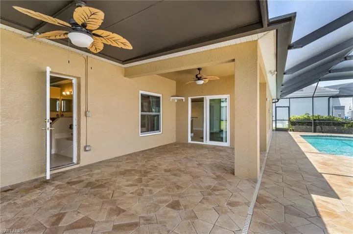 View of patio / terrace featuring a ceiling fan, an outdoor pool, and a lanai