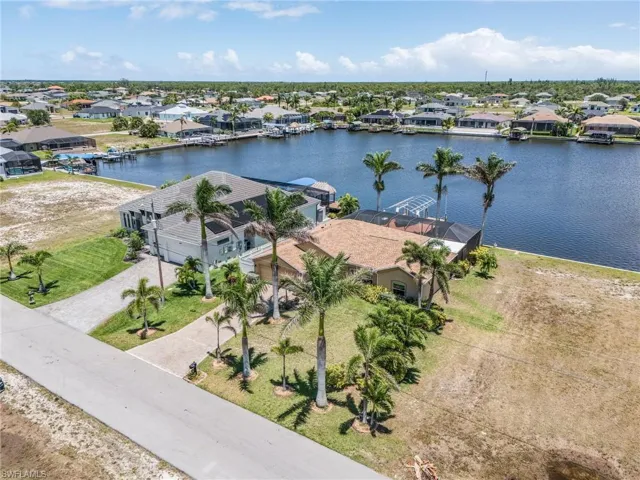 Aerial view of residential area featuring a large body of water
