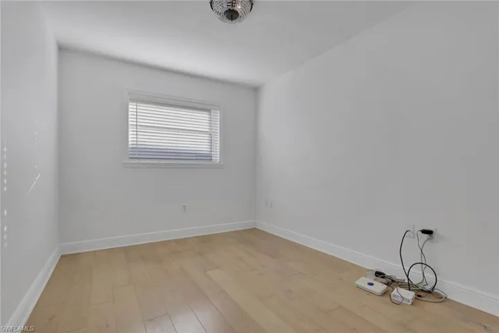 Unfurnished room with baseboards and light wood-style flooring