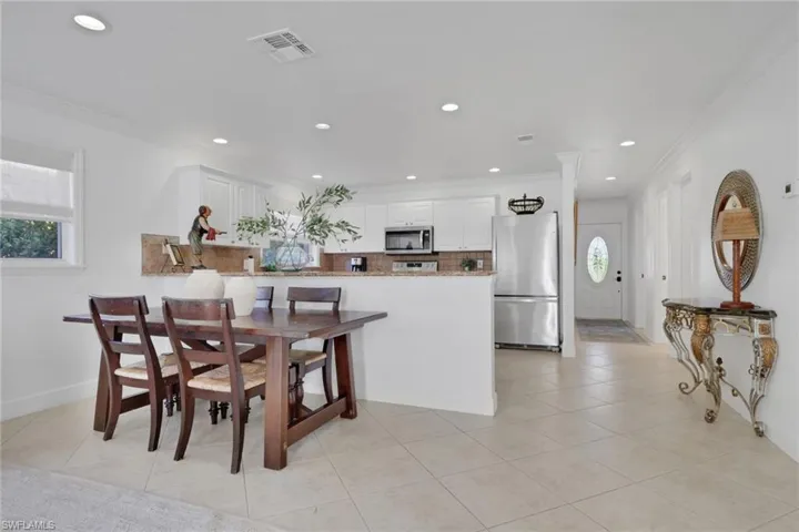 Dining area featuring recessed lighting, ornamental molding, and light tile patterned floors