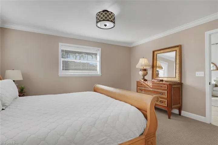 Bedroom featuring crown molding and carpet