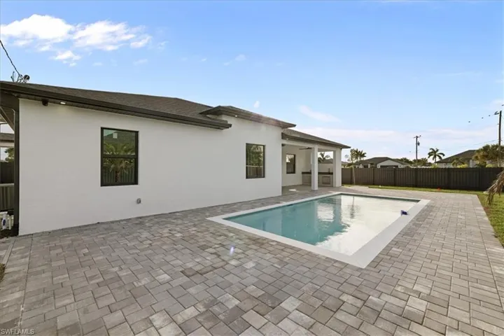 View of pool with a patio and a fenced backyard