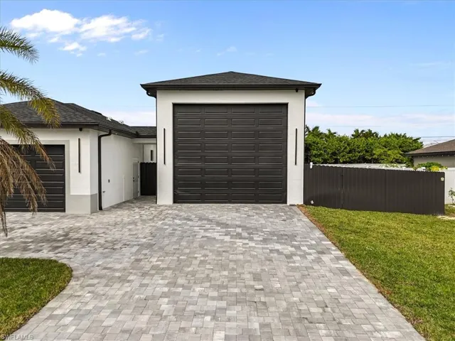 Garage featuring decorative driveway