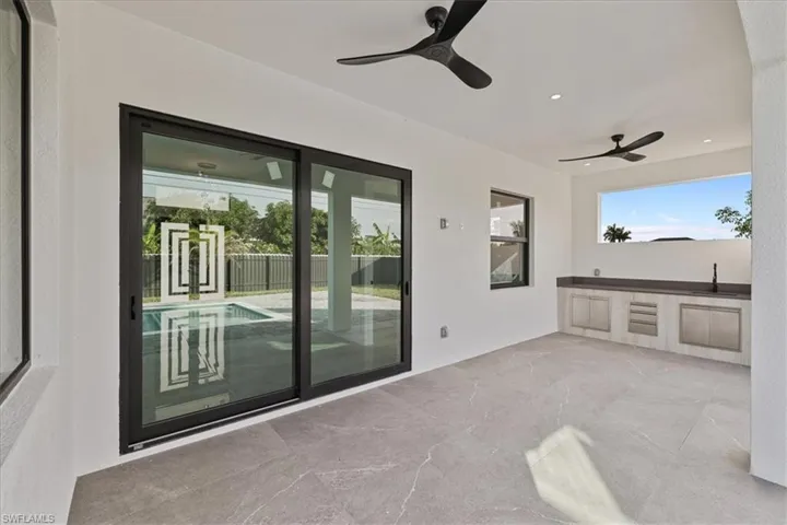 View of patio with exterior kitchen and a ceiling fan