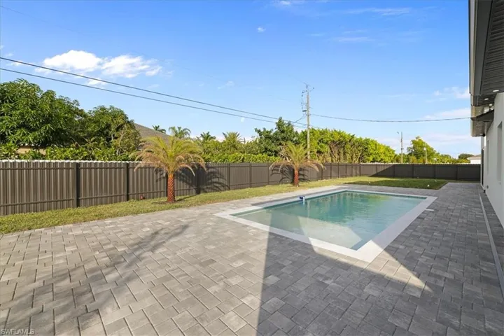 View of pool with a patio and a fenced backyard