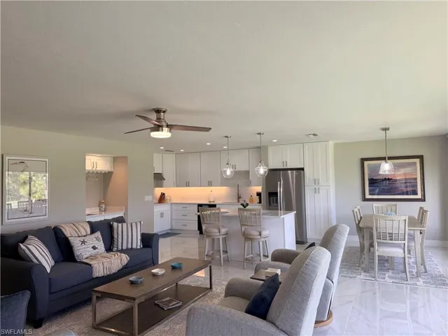 Living area with a ceiling fan and recessed lighting