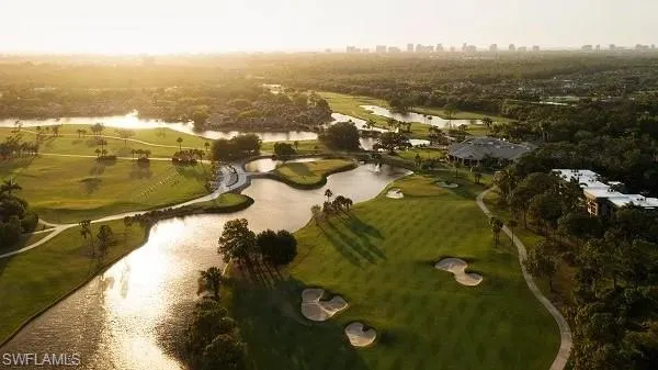 Drone / aerial view of a nearby body of water and a local golf course