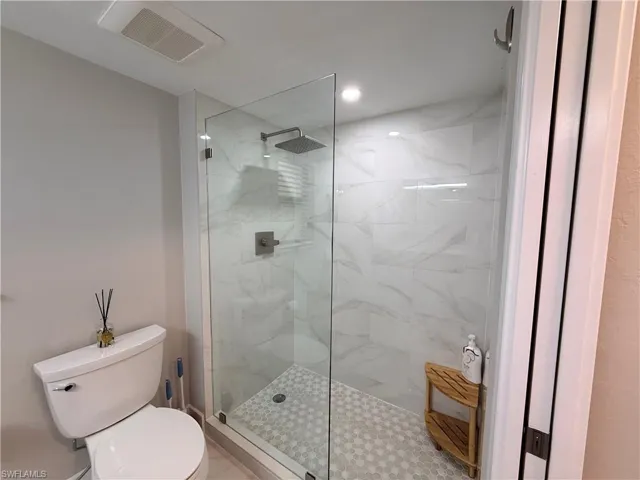 Bathroom featuring a marble finish shower