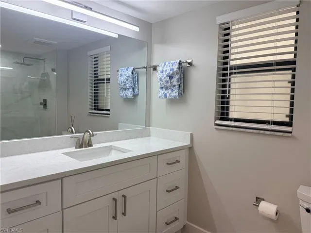 Bathroom with vanity and a stall shower