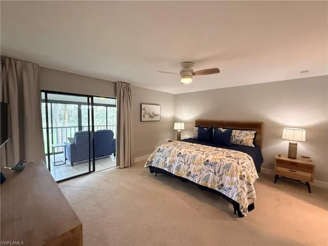Bedroom featuring light colored carpet, access to outside, and a ceiling fan