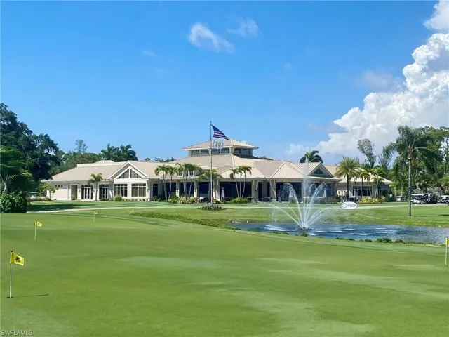 Surrounding community with view of golf course and a water view