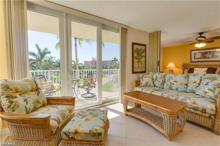 Living room featuring tile patterned floors and ceiling fan