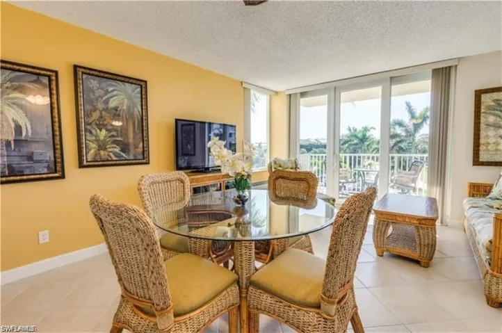 Dining area featuring light tile patterned flooring and a textured ceiling