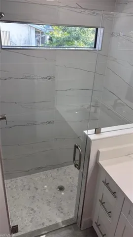 Full bath with vanity and a stall shower