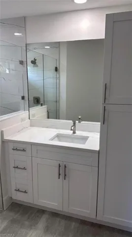 Full bath featuring a stall shower and vanity